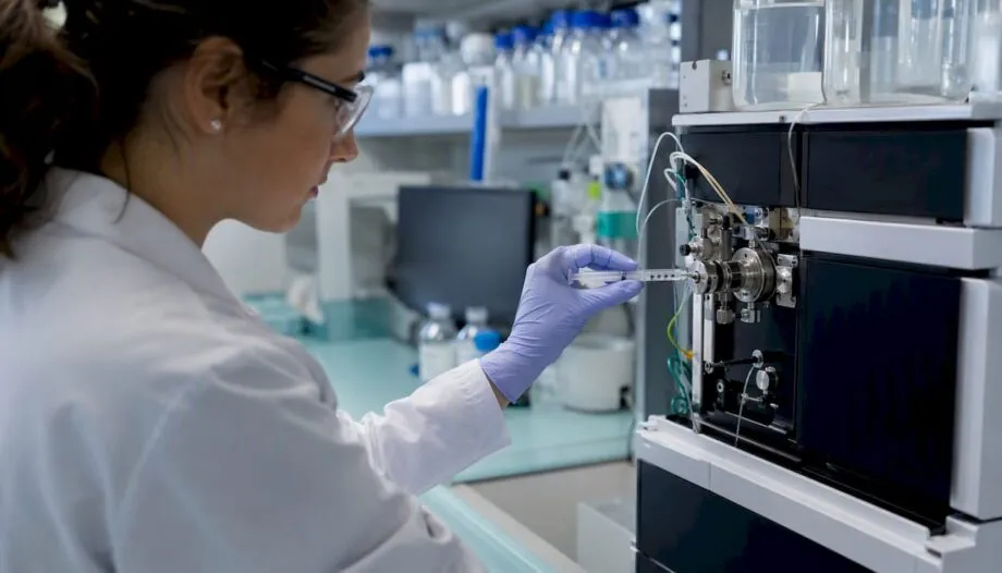 Scientist injecting peptide sample into HPLC machine