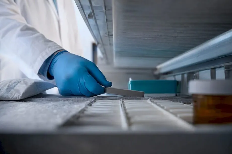 Researcher storing peptide samples in freezer